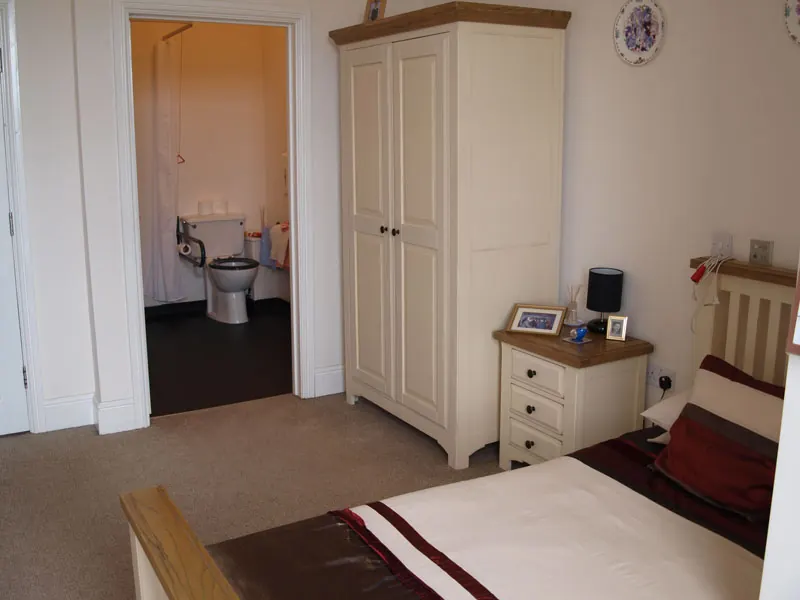 Bedroom with a wardrobe and an en-suite bathroom